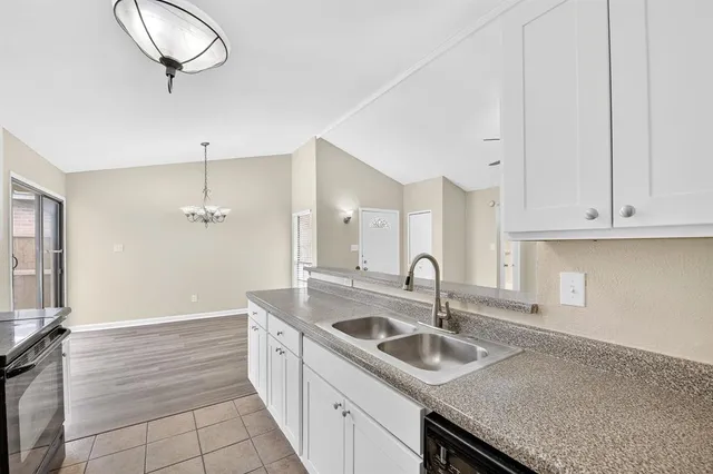 a kitchen with sink and cabinets