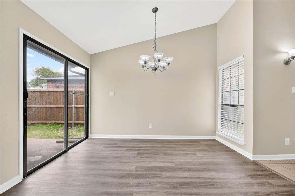 6018 McAfee Drive The Colony, TX 75056 - Photo 17 of 28 wooden floor in an empty room with a window