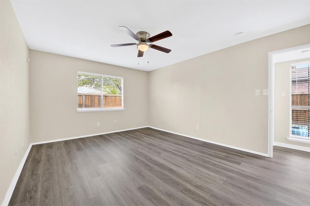 6018 McAfee Drive The Colony, TX 75056 - Photo 18 of 28 wooden floor in an empty room with a window