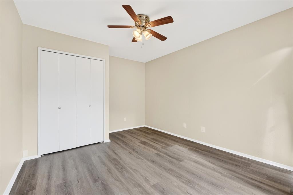 6018 McAfee Drive The Colony, TX 75056 - Photo 23 of 28 an empty room with wooden floor and a ceiling fan
