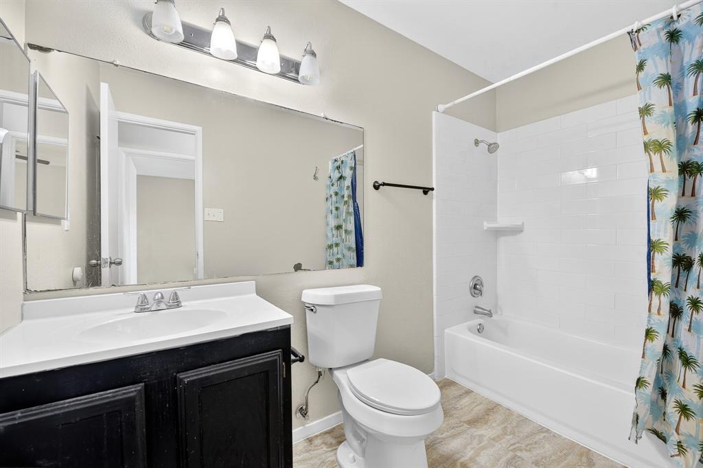 6018 McAfee Drive The Colony, TX 75056 - Photo 3 of 28 a bathroom with a sink a toilet and shower