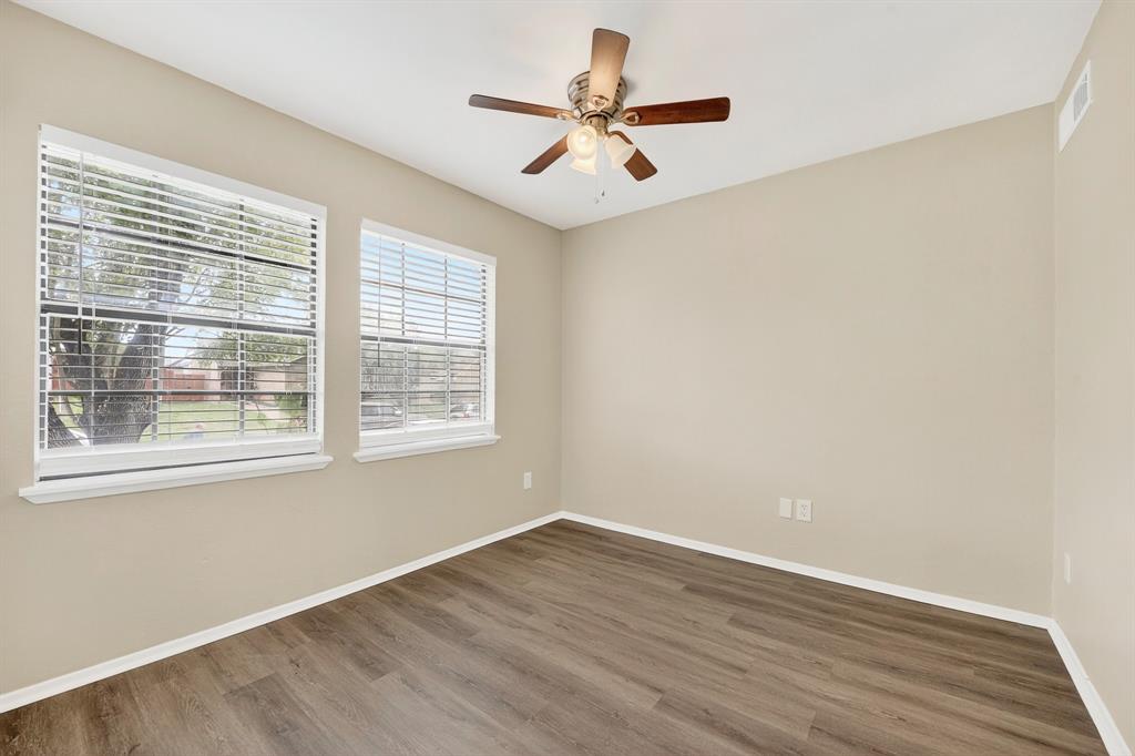 6018 McAfee Drive The Colony, TX 75056 - Photo 5 of 28 a view of an empty room with wooden floor and a window