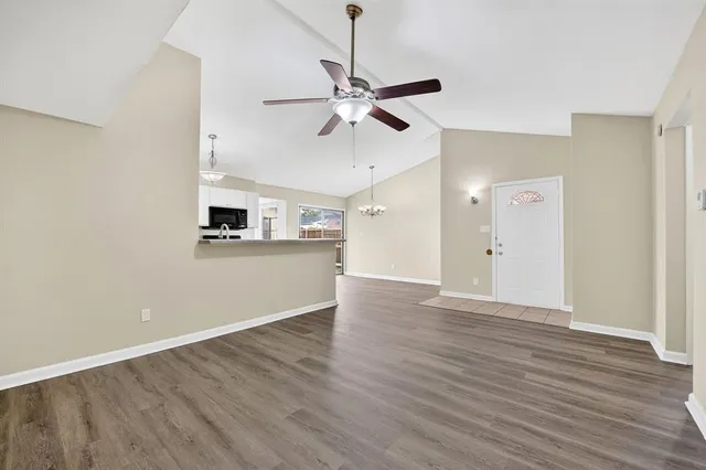 a view of a kitchen with a microwave and a ceiling fan