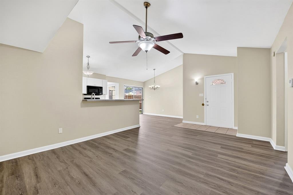6018 McAfee Drive The Colony, TX 75056 - Photo 7 of 28 a view of a kitchen with a microwave and a ceiling fan