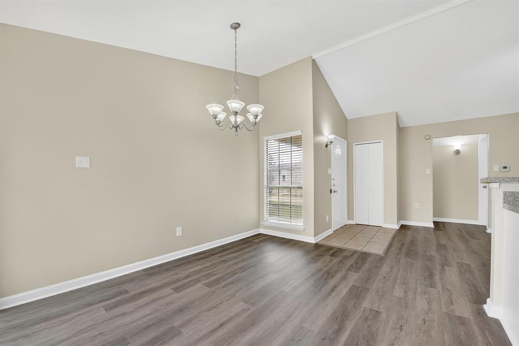 6018 McAfee Drive The Colony, TX 75056 - Photo 10 of 28 a view of an empty room with wooden floor and a window