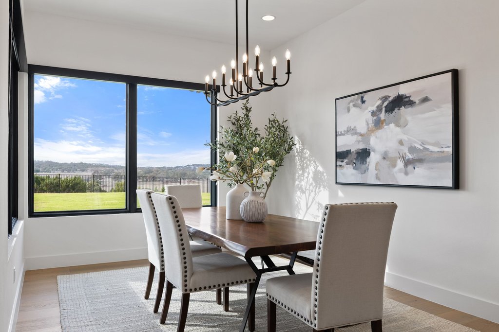 6316 Caudill Lane Austin, TX 78738 - Photo 10 of 40 a dining room with furniture a large window and a chandelier
