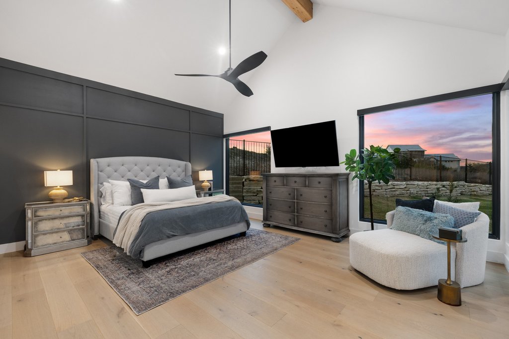 6316 Caudill Lane Austin, TX 78738 - Photo 15 of 40 a spacious bedroom with a bed and a flat screen tv