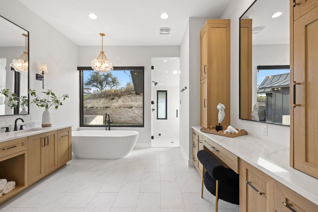 6316 Caudill Lane Austin, TX 78738 - Photo 17 of 40 a spacious bathroom with a granite countertop tub sink and mirror