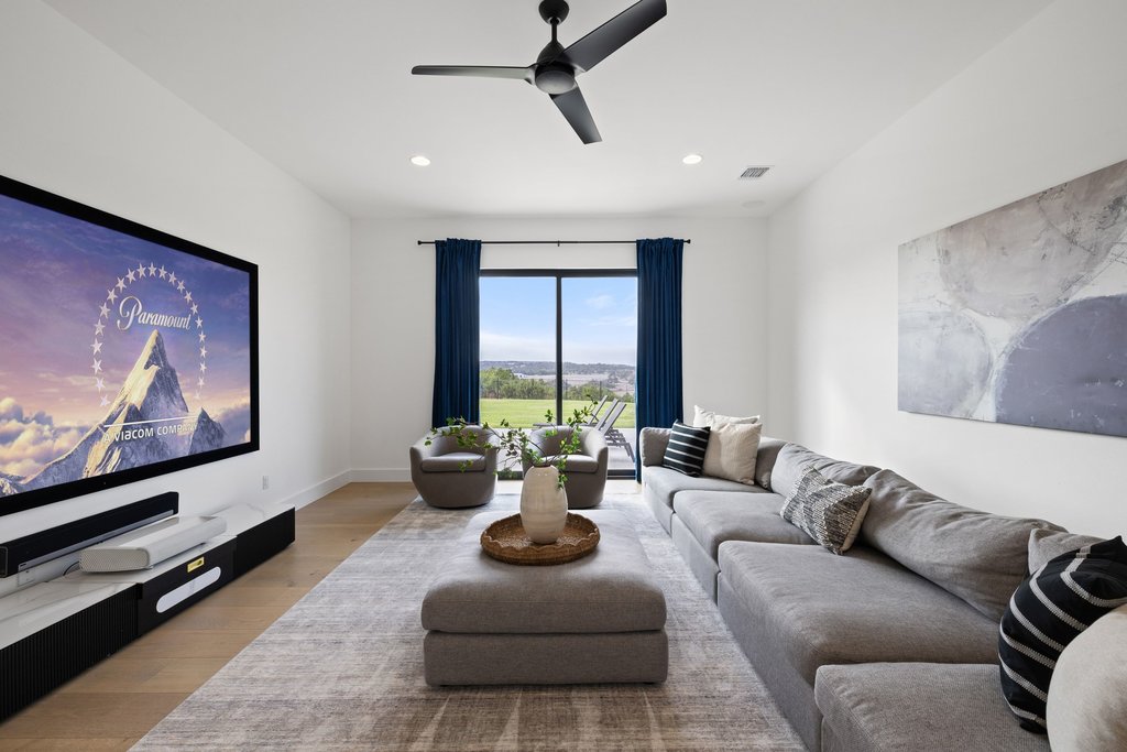 6316 Caudill Lane Austin, TX 78738 - Photo 21 of 40 a living room with furniture flat screen tv and a large window