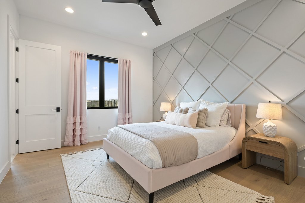 6316 Caudill Lane Austin, TX 78738 - Photo 27 of 40 a bedroom with a bed and a chandelier