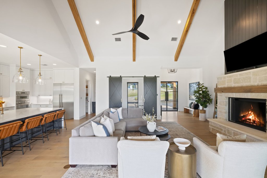 6316 Caudill Lane Austin, TX 78738 - Photo 9 of 40 a living room with furniture a fireplace and a flat screen tv