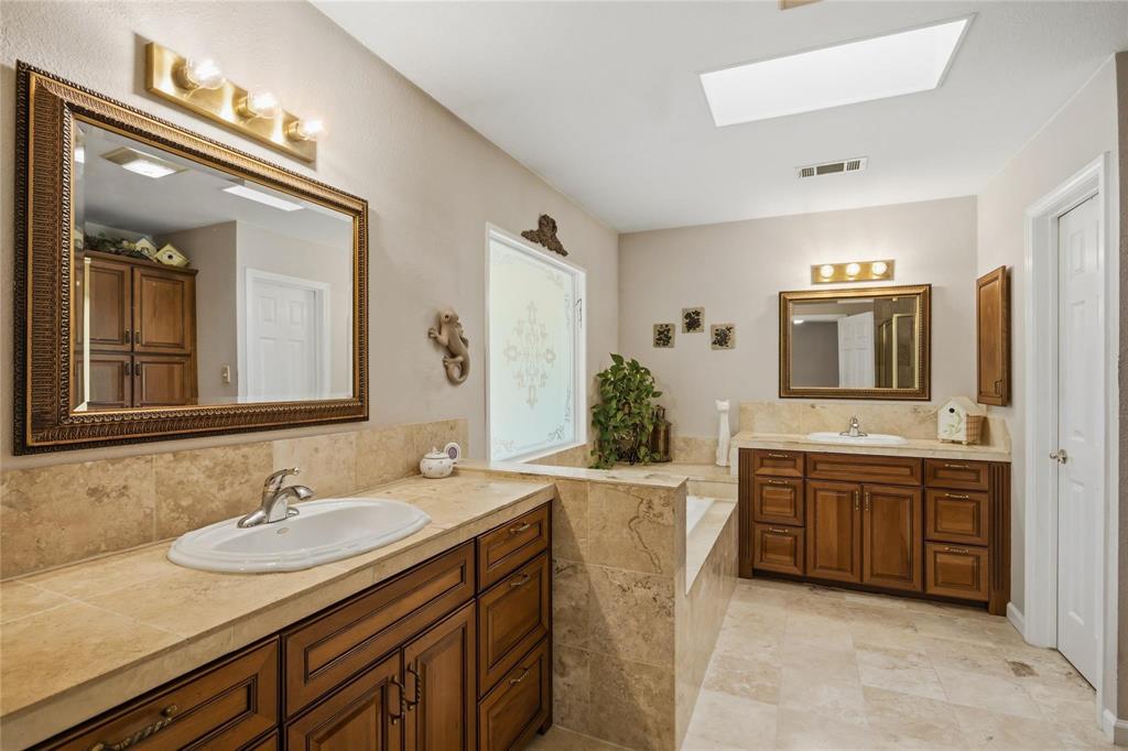 265 East Dove Road Southlake, TX 76092 - Photo 18 of 39 a bathroom with a granite countertop sink and a mirror