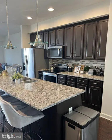 a kitchen with a stove a sink and a refrigerator
