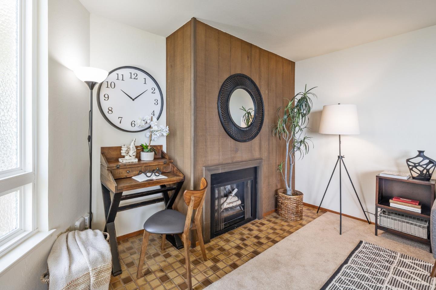 320 Vallejo Drive, Unit 23 Millbrae, CA 94030 - Photo 7 of 50 a living room with furniture a clock and a fireplace