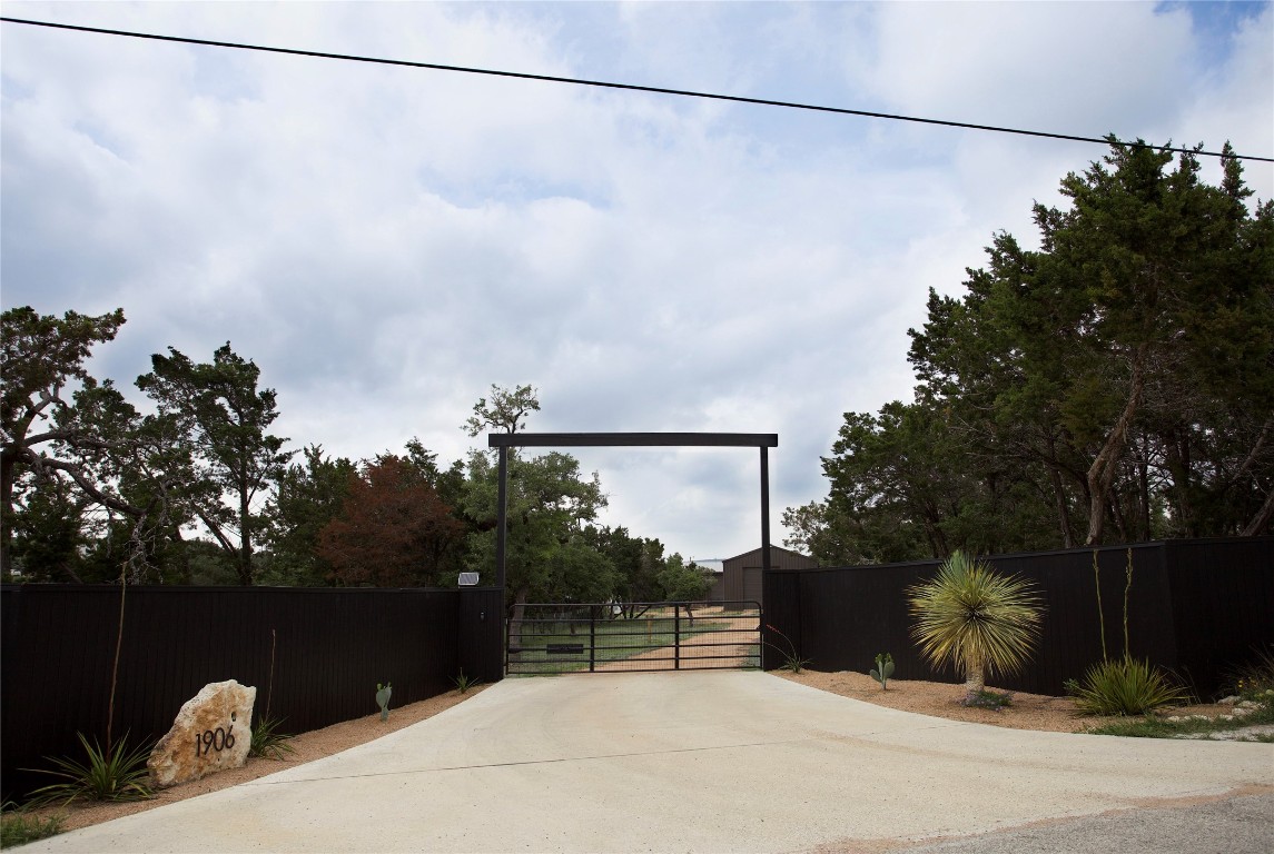 a terrace with a bench and trees in the background