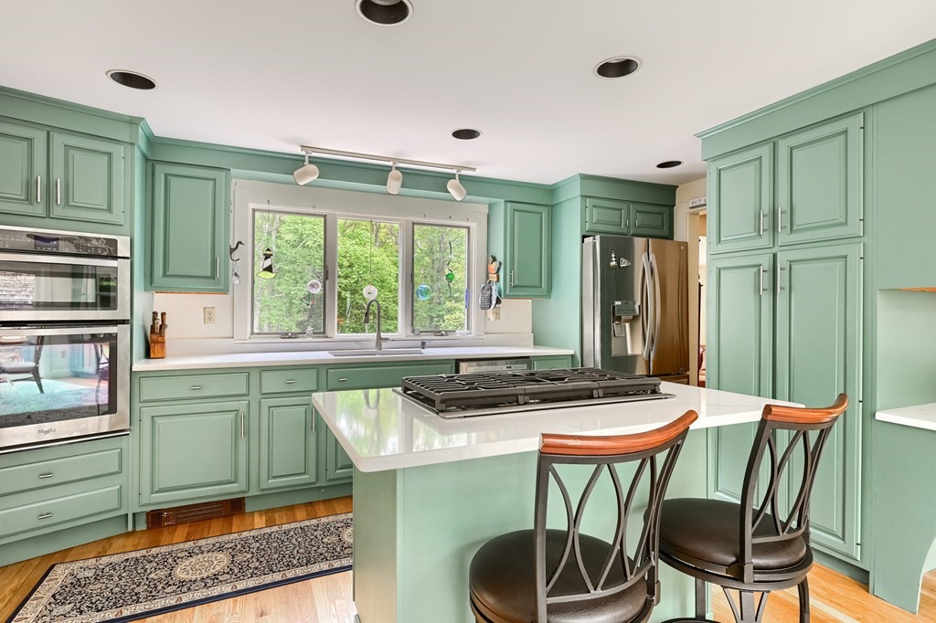 214 Park Avenue Barnstable, MA 02632 - Photo 15 of 42 a kitchen with stainless steel appliances granite countertop a table and chairs in it