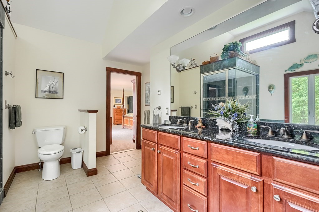 214 Park Avenue Barnstable, MA 02632 - Photo 30 of 42 a spacious bathroom with a double vanity sink a large mirror a toilet and a shower