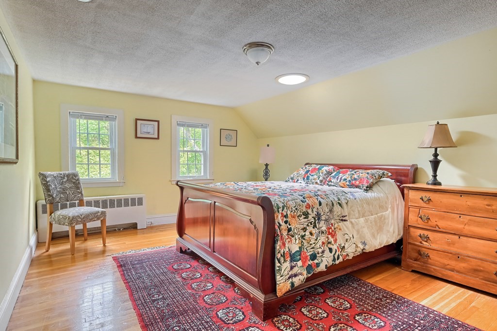 214 Park Avenue Barnstable, MA 02632 - Photo 31 of 42 a bedroom with a bed and wooden floor