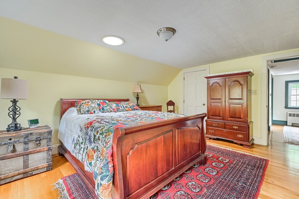 214 Park Avenue Barnstable, MA 02632 - Photo 32 of 42 a bedroom with a bed and wooden floor