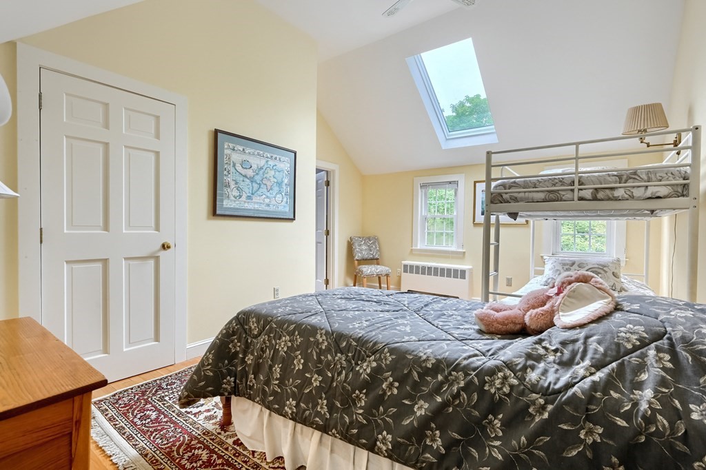 214 Park Avenue Barnstable, MA 02632 - Photo 33 of 42 a bedroom with a bed and wooden floor