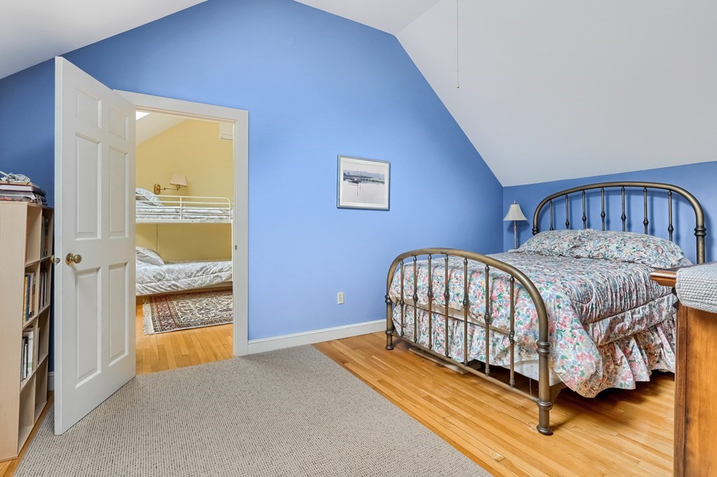 214 Park Avenue Barnstable, MA 02632 - Photo 37 of 42 a bedroom with a bed and wooden floor
