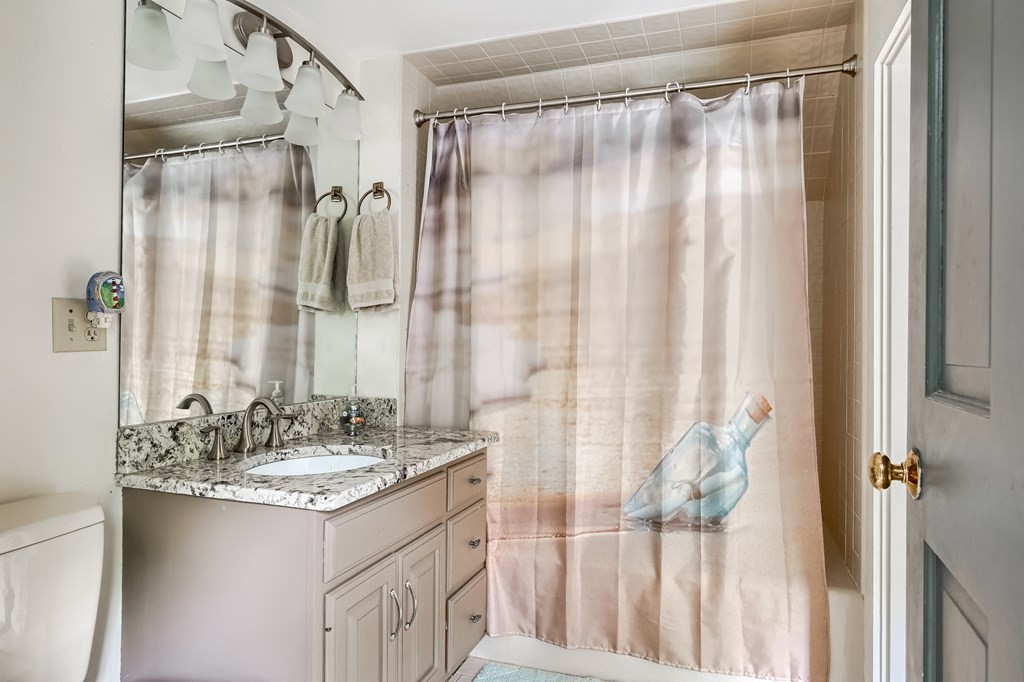 214 Park Avenue Barnstable, MA 02632 - Photo 38 of 42 a bathroom with a granite countertop sink and a mirror