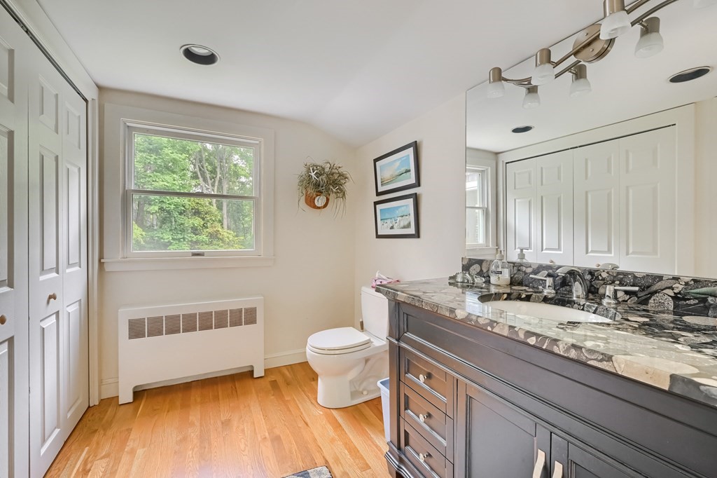 214 Park Avenue Barnstable, MA 02632 - Photo 39 of 42 a bathroom with a granite countertop sink toilet and mirror