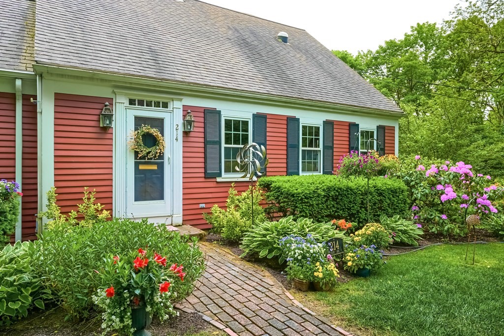 214 Park Avenue Barnstable, MA 02632 - Photo 4 of 42 a front view of a house with a flower garden