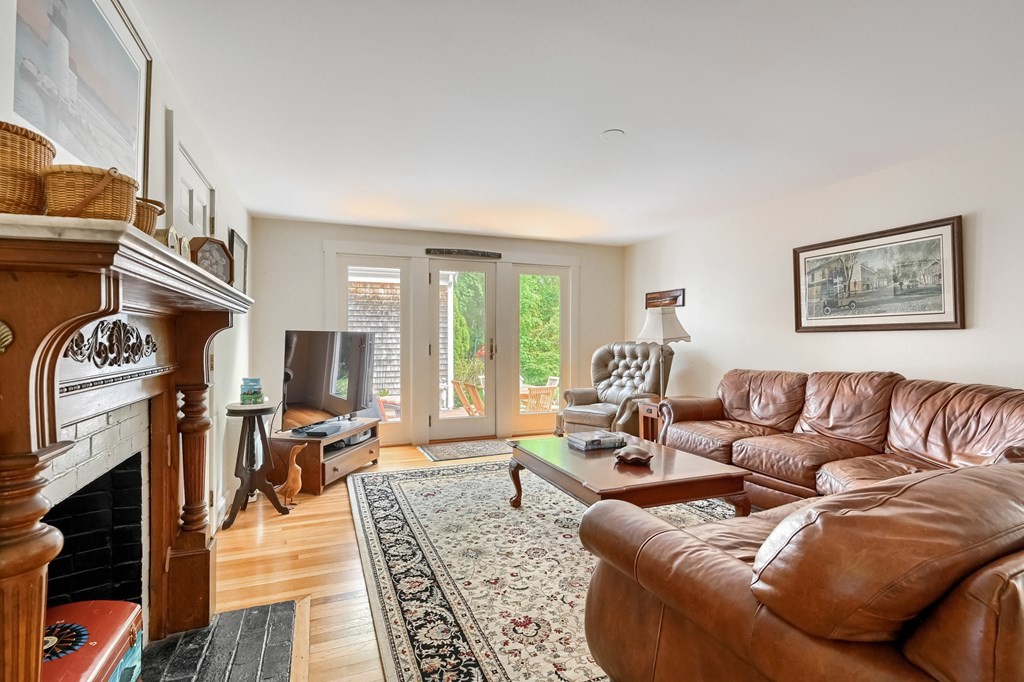 214 Park Avenue Barnstable, MA 02632 - Photo 10 of 42 a living room with furniture a fireplace and a flat screen tv