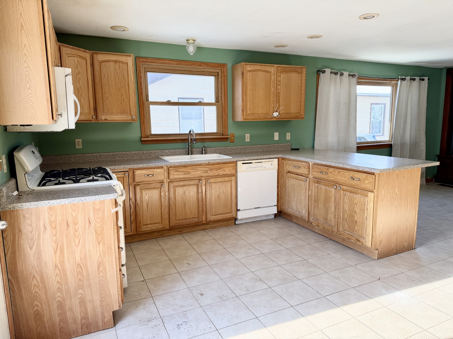 1429 Phelps Street Ottawa, IL 61350 - Photo 2 of 27 a kitchen with stainless steel appliances granite countertop a stove a sink and a microwave
