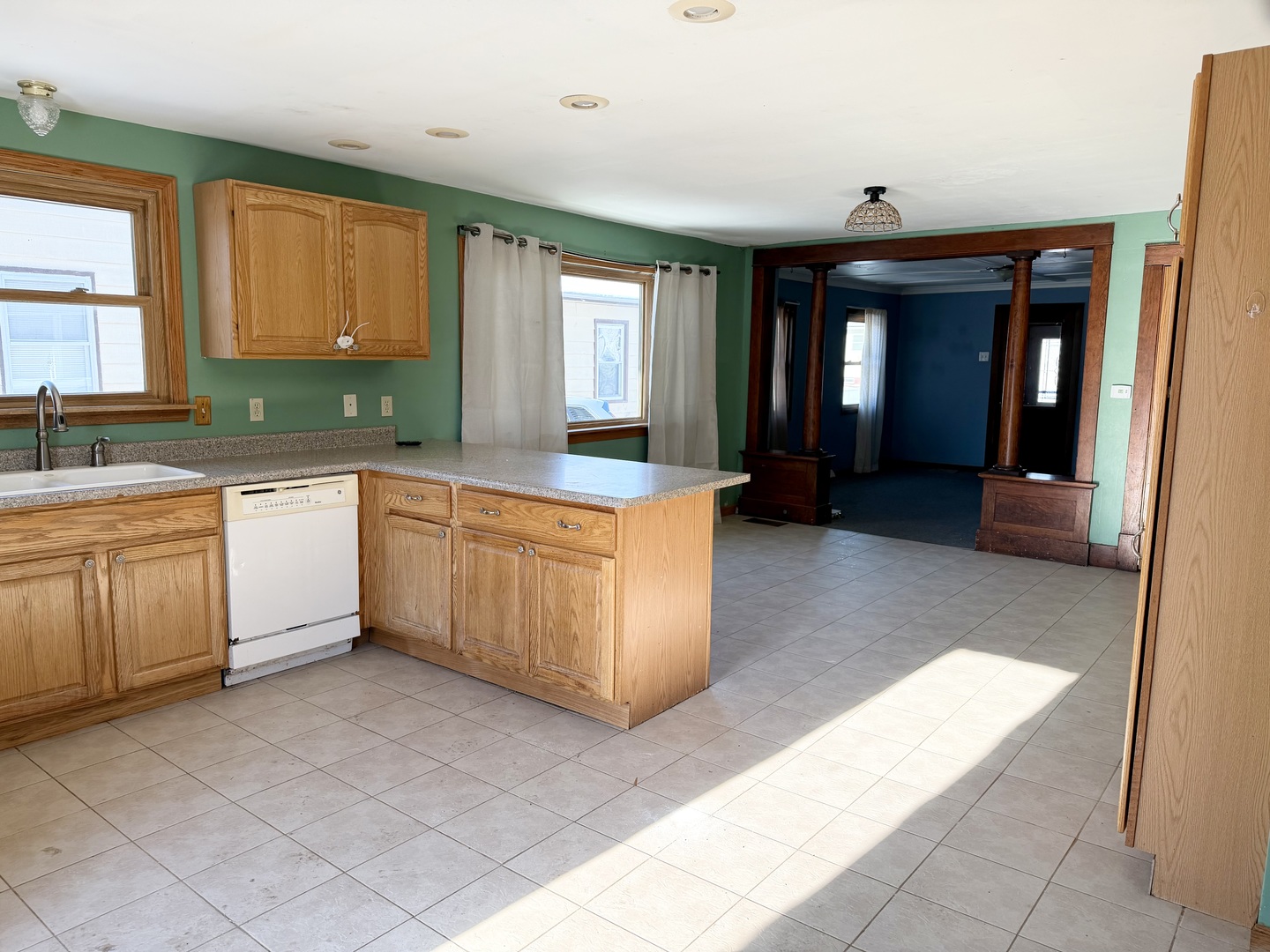 1429 Phelps Street Ottawa, IL 61350 - Photo 3 of 27 a large kitchen with kitchen island granite countertop a stove a sink and white cabinets