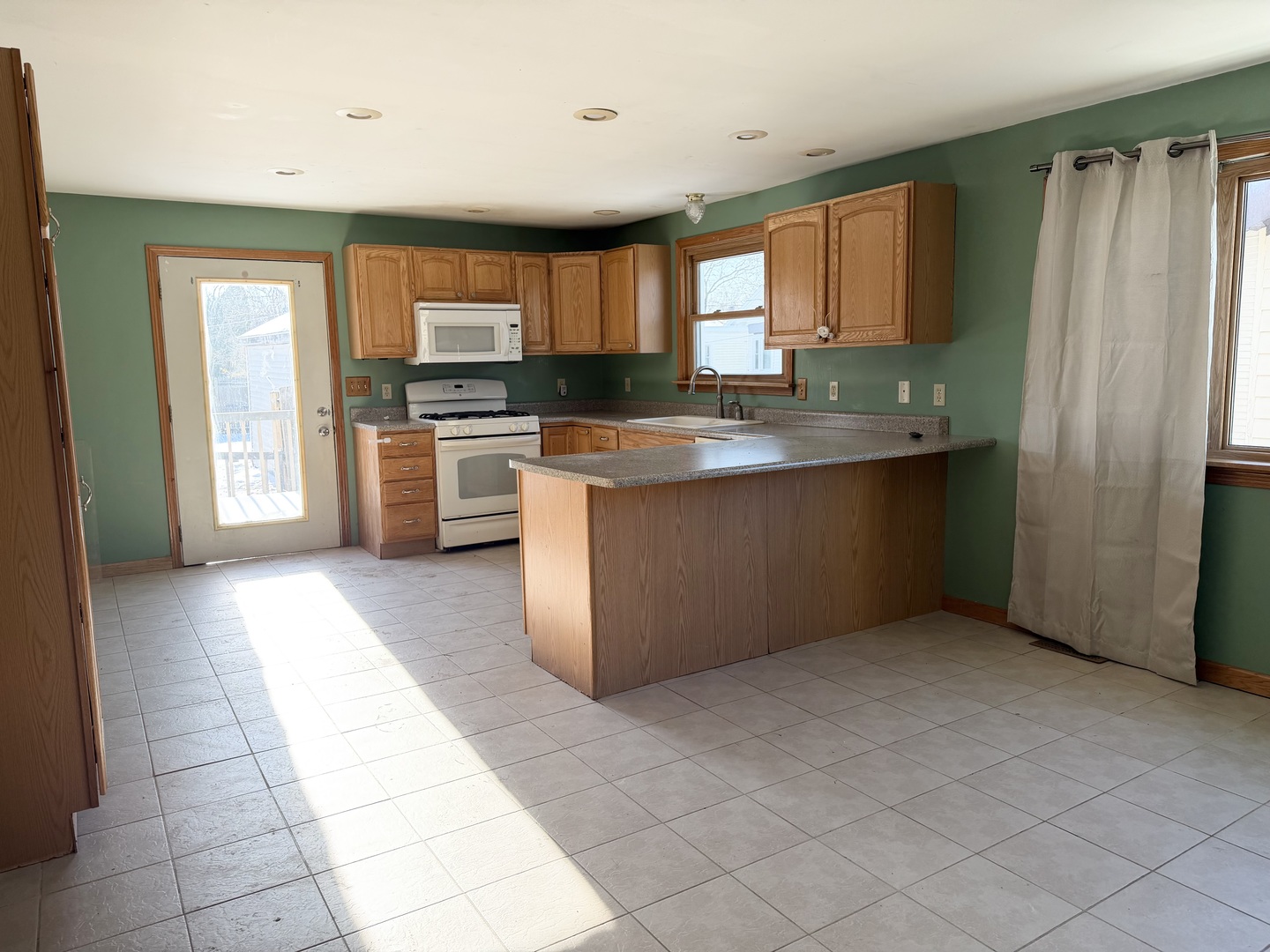 1429 Phelps Street Ottawa, IL 61350 - Photo 5 of 27 a kitchen with stainless steel appliances granite countertop a refrigerator and a sink