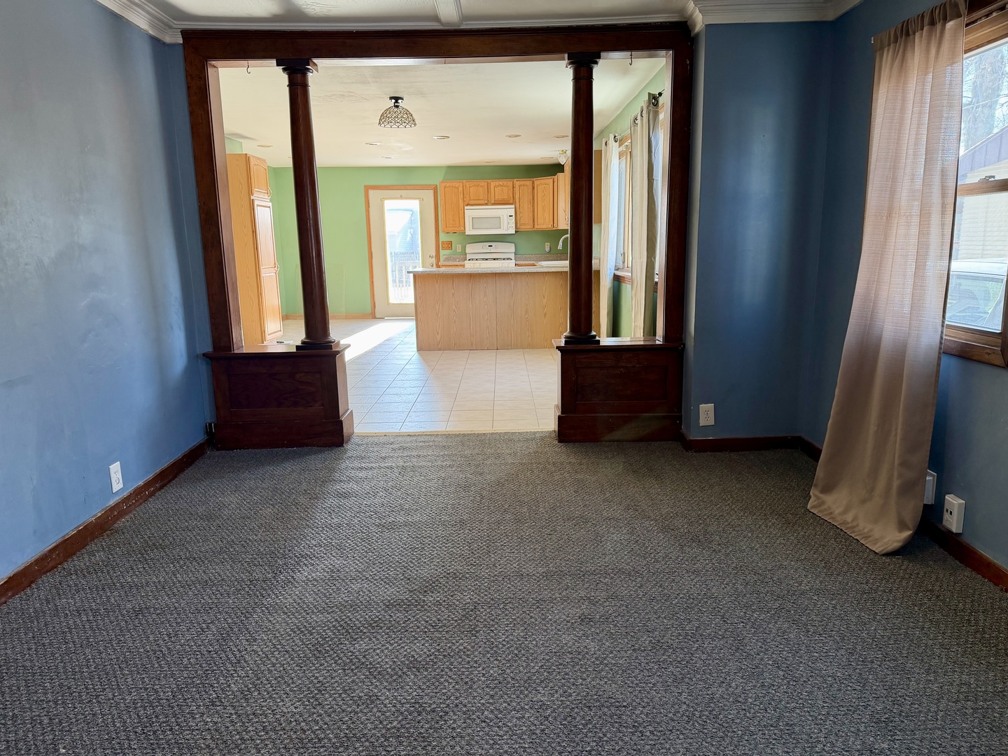 1429 Phelps Street Ottawa, IL 61350 - Photo 9 of 27 a view of an empty room with a fireplace and windows