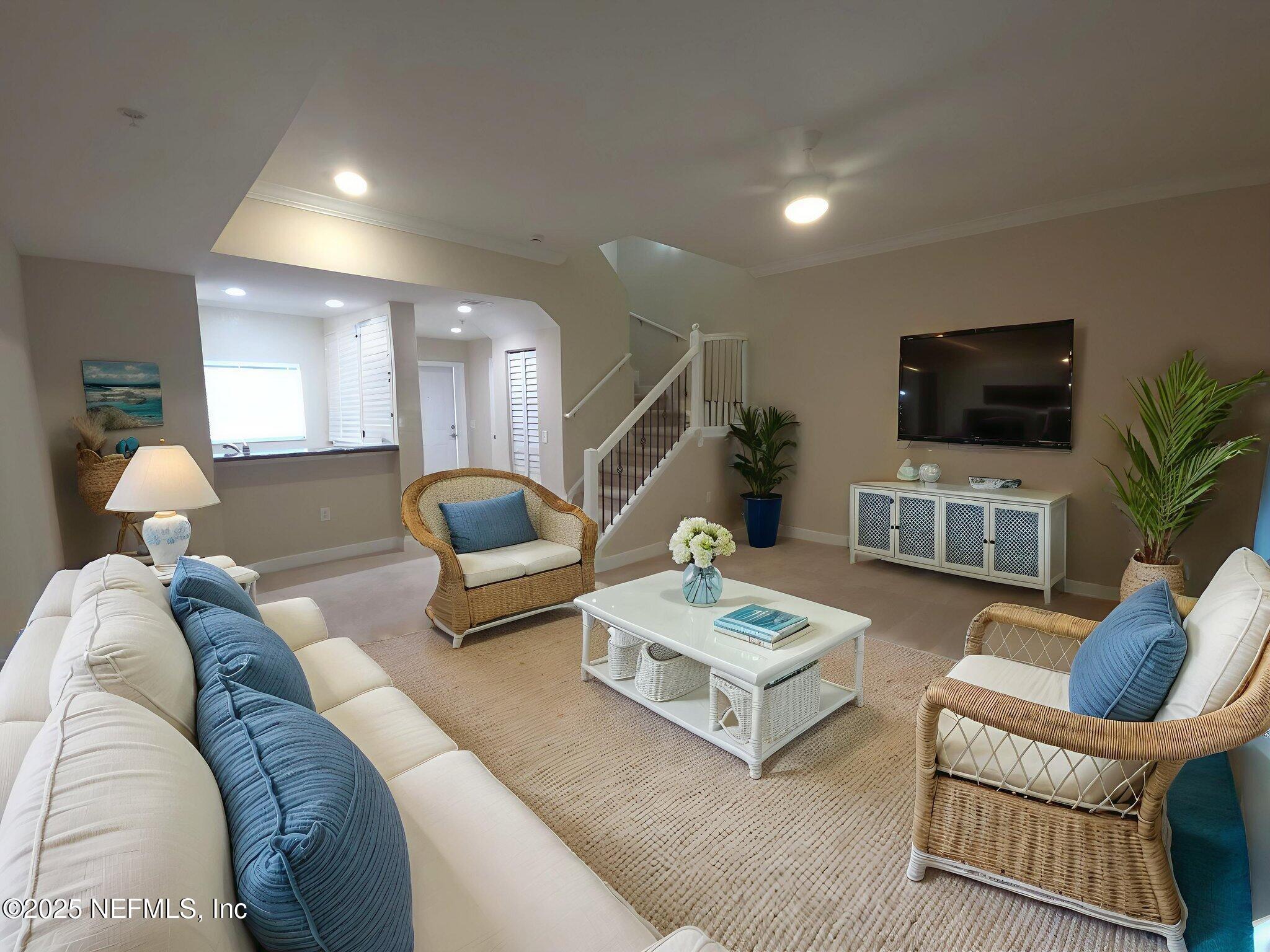 9745 Touchton Road, Unit 427 Jacksonville, FL 32246 - Photo 14 of 52 a living room with furniture and a flat screen tv