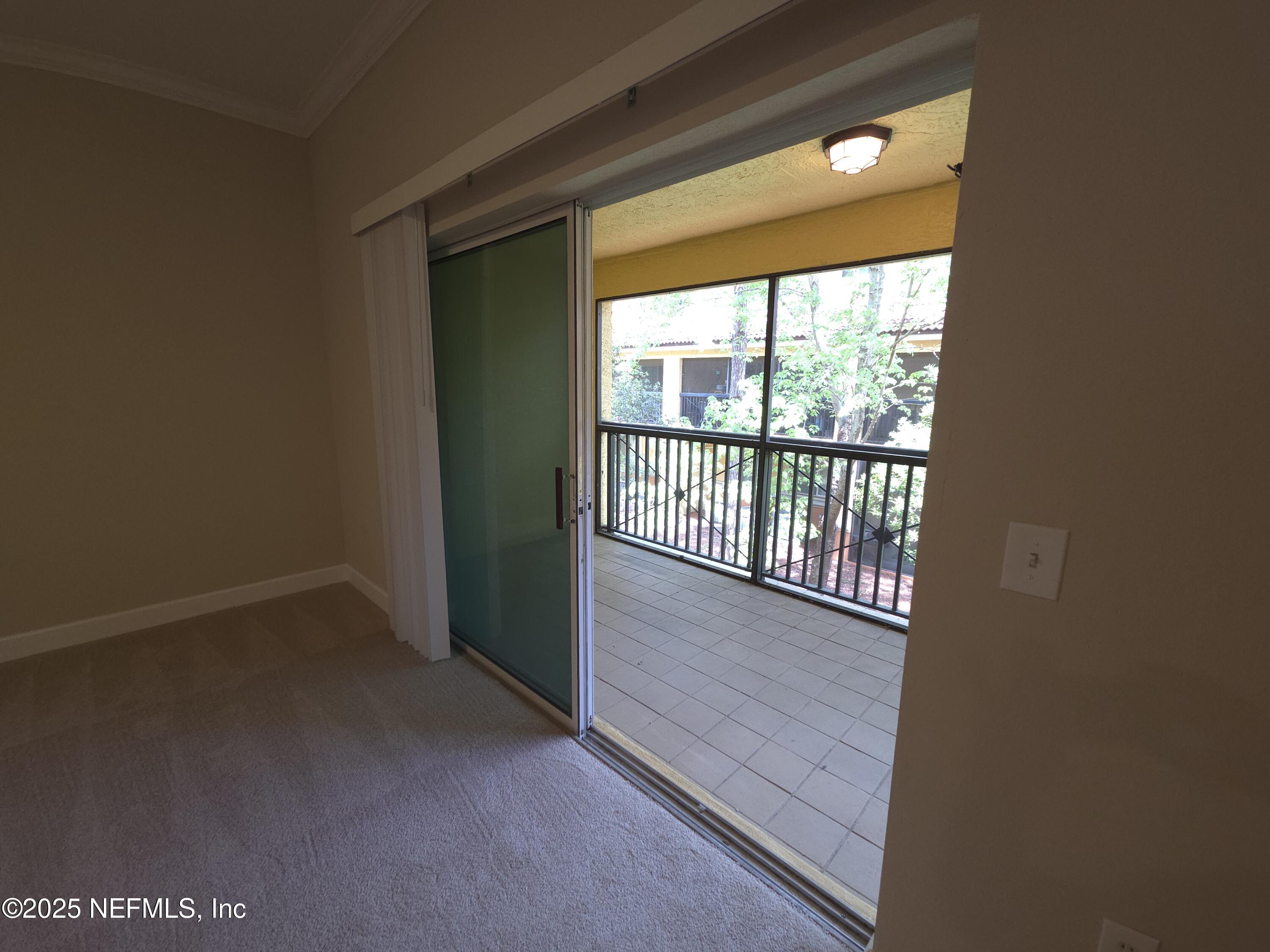 9745 Touchton Road, Unit 427 Jacksonville, FL 32246 - Photo 15 of 52 an empty room with wooden floor and windows