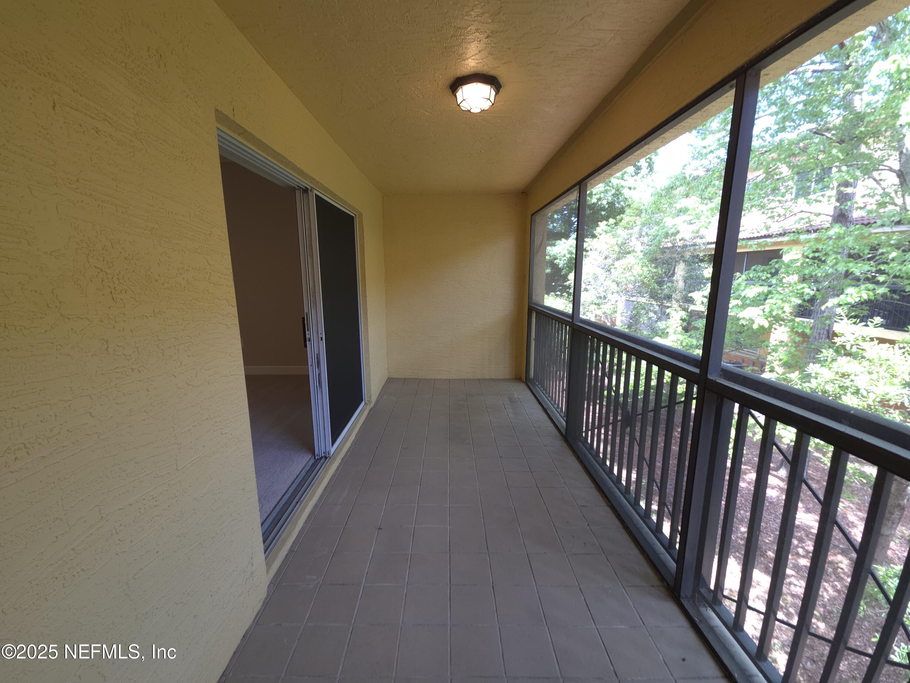 9745 Touchton Road, Unit 427 Jacksonville, FL 32246 - Photo 16 of 52 a view of a hallway with wooden floor and stairs