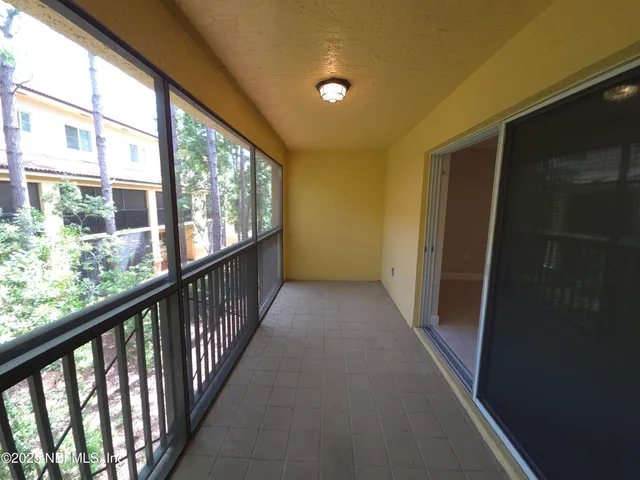 a view of a balcony with wooden floor