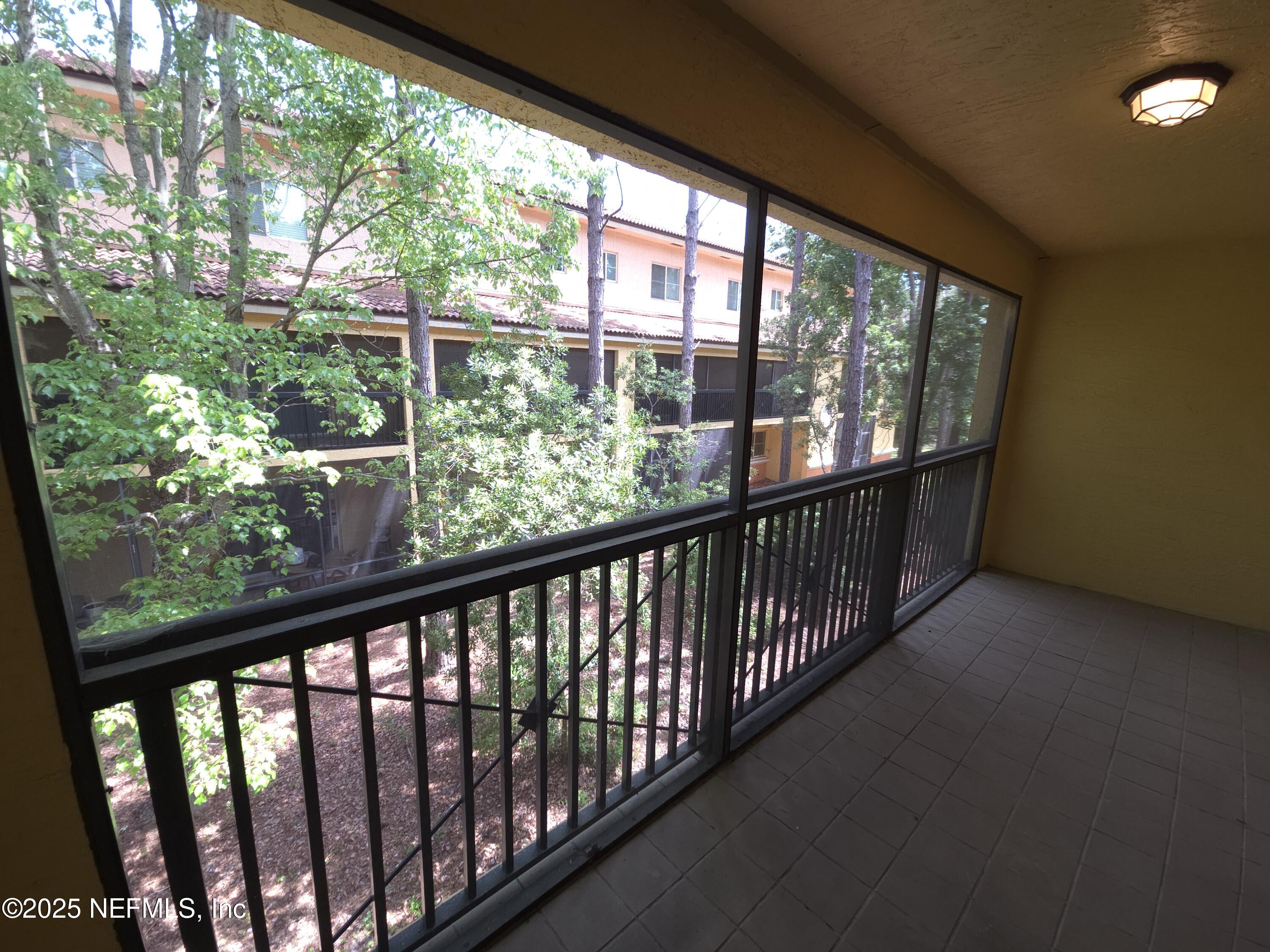 9745 Touchton Road, Unit 427 Jacksonville, FL 32246 - Photo 18 of 52 a view of a balcony with wooden floor