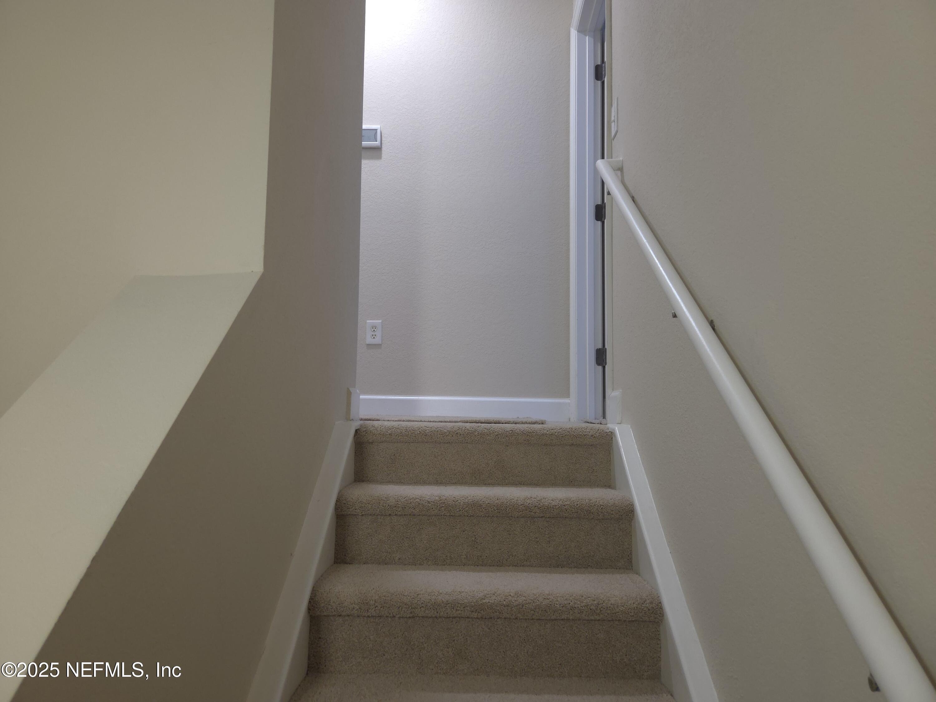 9745 Touchton Road, Unit 427 Jacksonville, FL 32246 - Photo 20 of 52 a view of staircase with white walls and white door