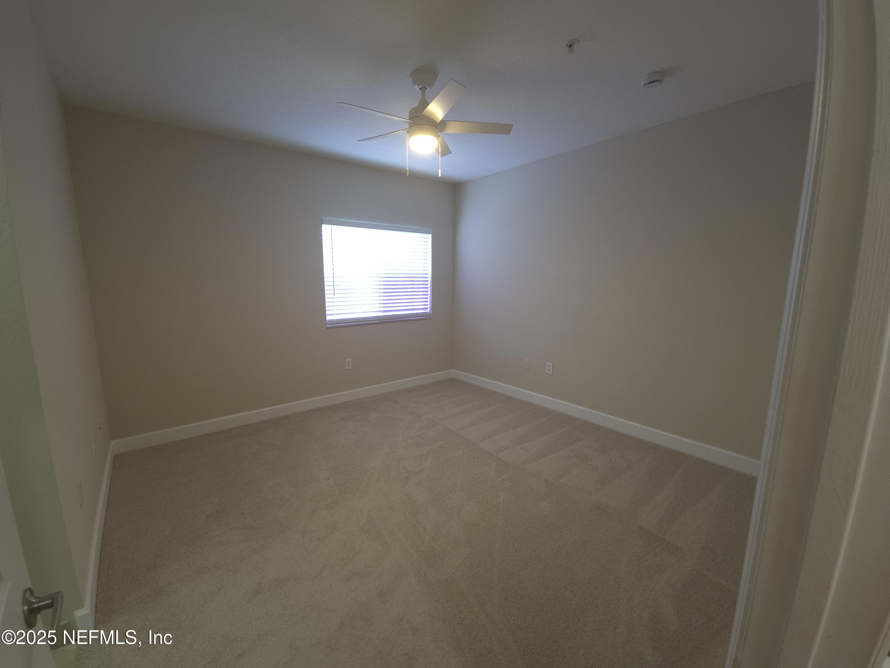 9745 Touchton Road, Unit 427 Jacksonville, FL 32246 - Photo 21 of 52 a view of an empty room with a window