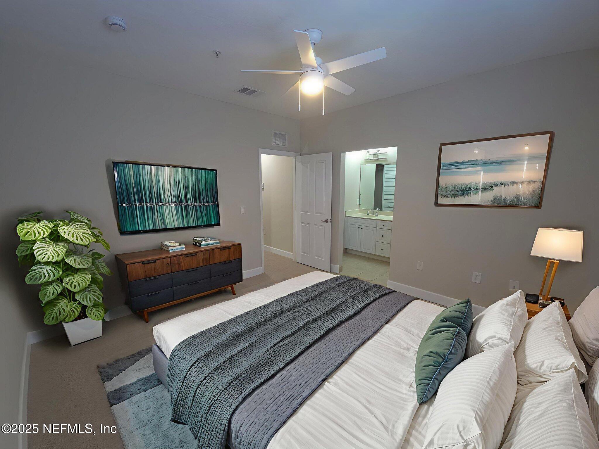 9745 Touchton Road, Unit 427 Jacksonville, FL 32246 - Photo 23 of 52 a bedroom with bed and a couch