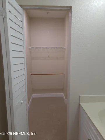 a view of an empty room with a fan