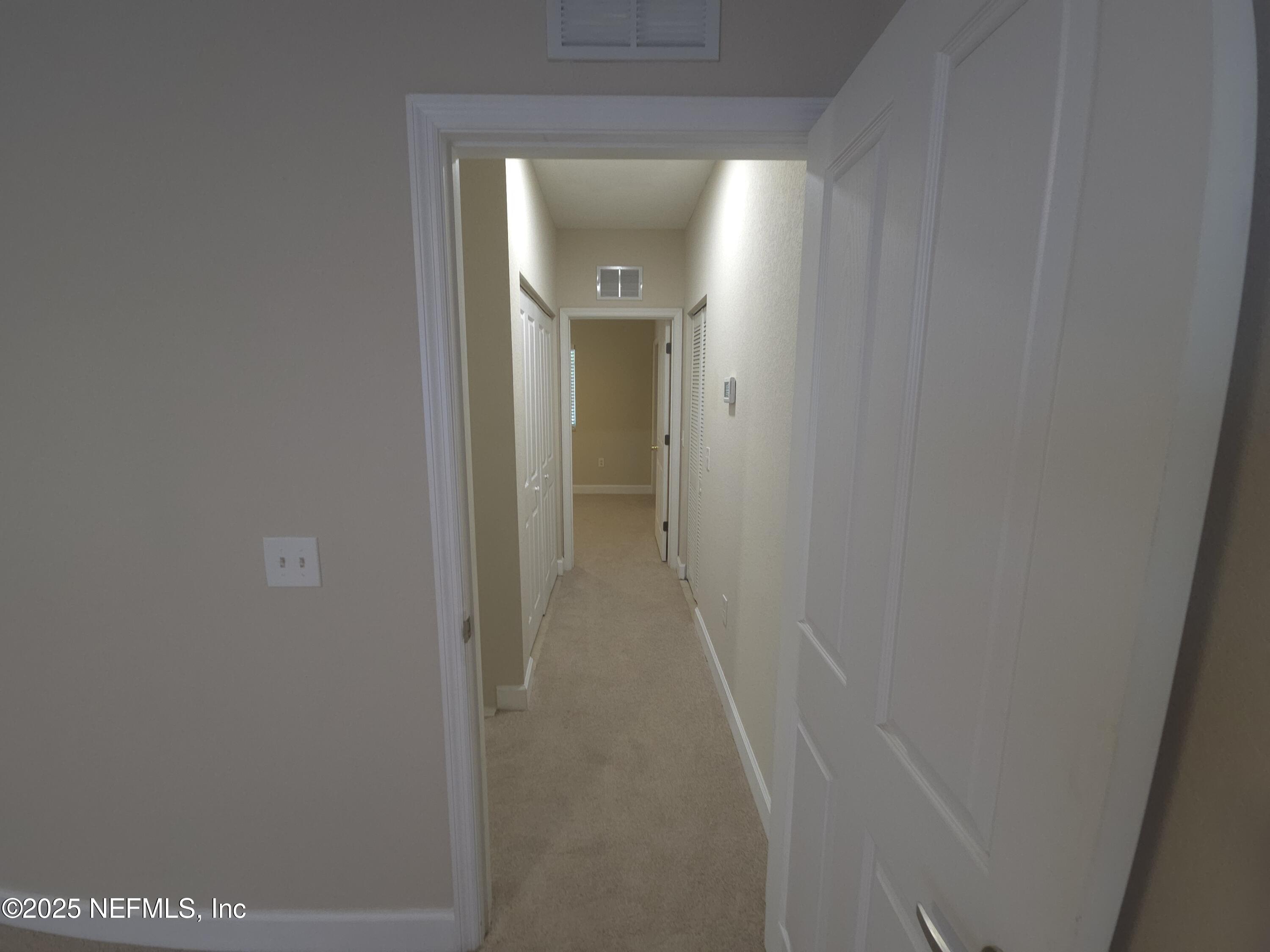 9745 Touchton Road, Unit 427 Jacksonville, FL 32246 - Photo 27 of 52 a view of a hallway with wooden floor