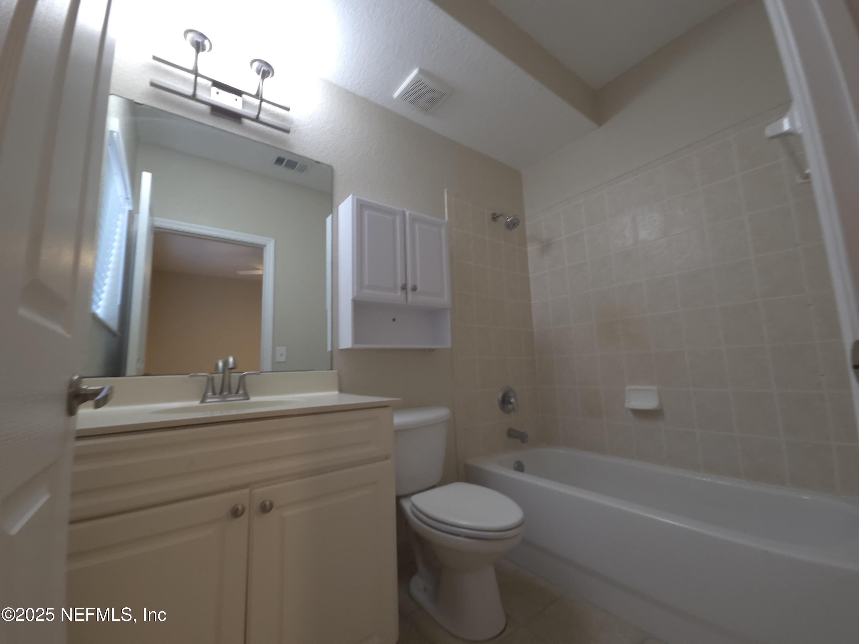 9745 Touchton Road, Unit 427 Jacksonville, FL 32246 - Photo 31 of 52 a bathroom with a sink a toilet and shower