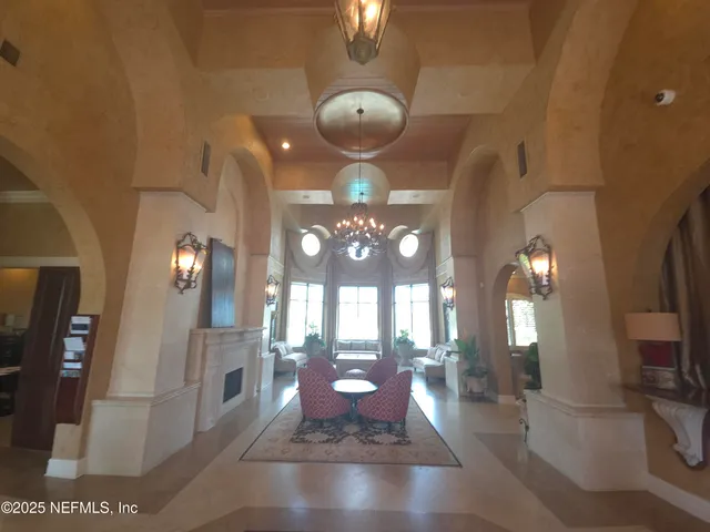 a lobby with furniture and a potted plant