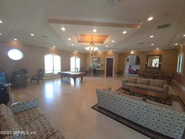 a view of a livingroom with furniture and windows