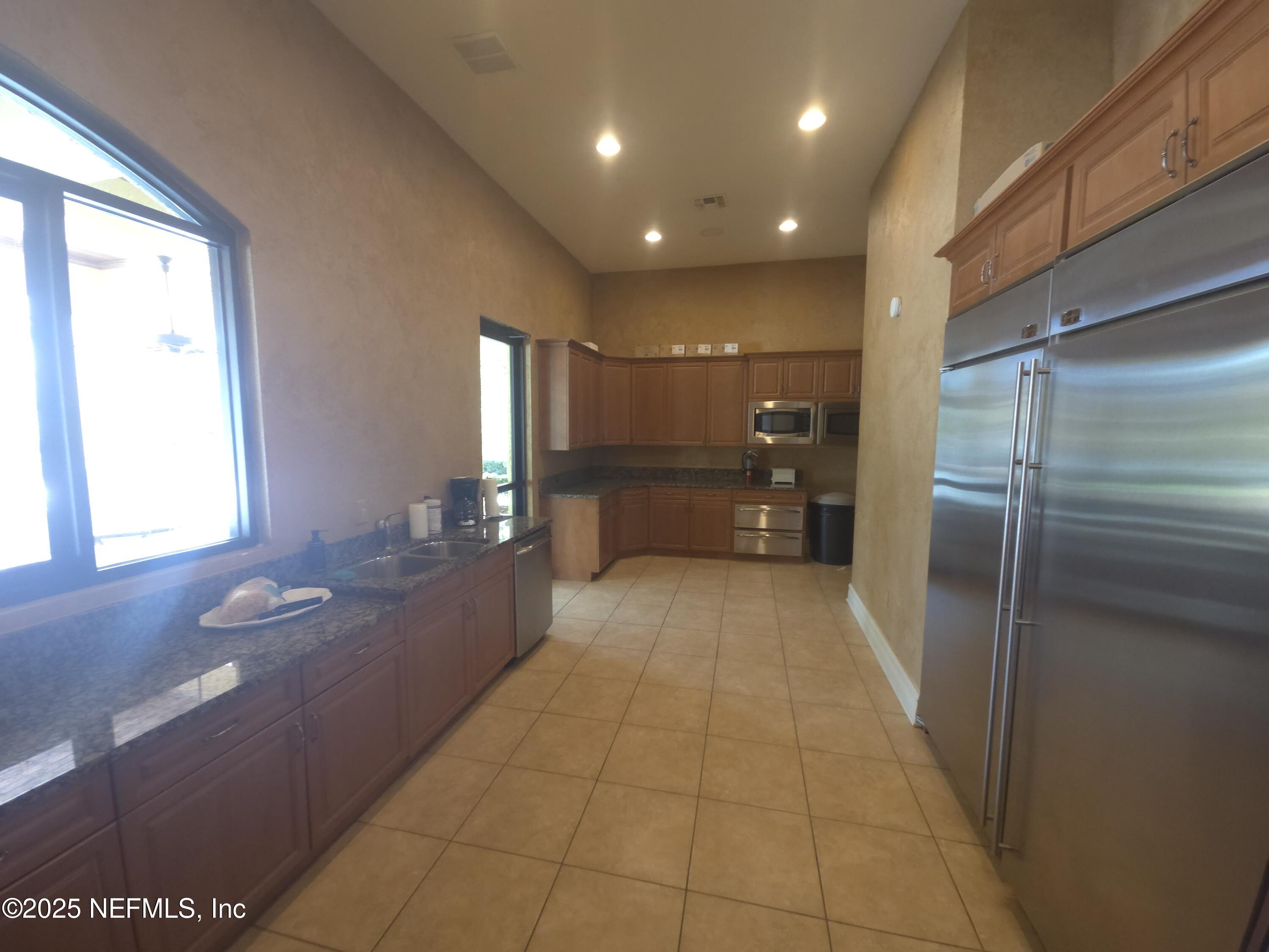 9745 Touchton Road, Unit 427 Jacksonville, FL 32246 - Photo 42 of 52 a bathroom with a sink a toilet and a large mirror