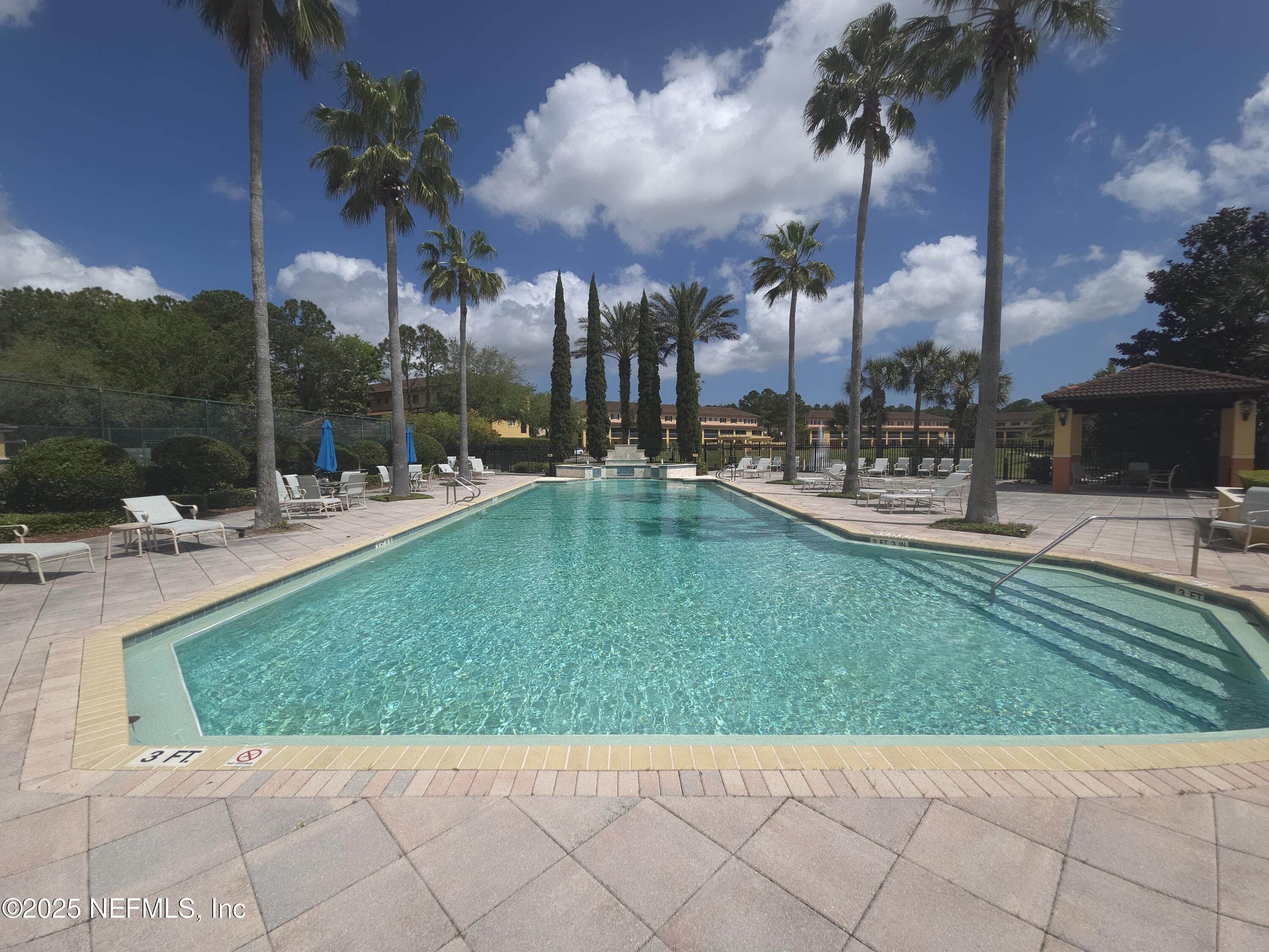9745 Touchton Road, Unit 427 Jacksonville, FL 32246 - Photo 48 of 52 a view of a backyard with a patio and swimming pool