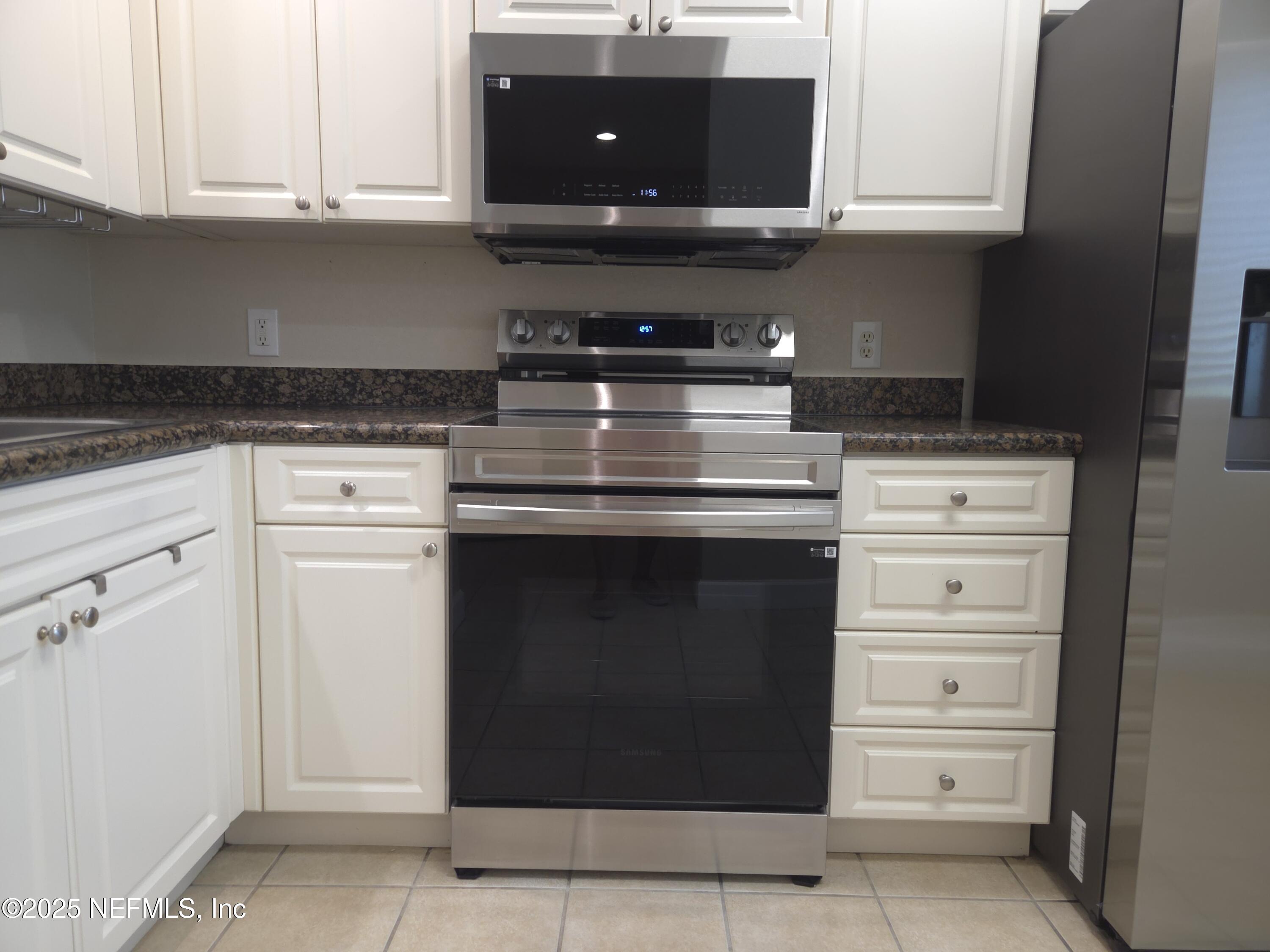 9745 Touchton Road, Unit 427 Jacksonville, FL 32246 - Photo 8 of 52 a stove top oven sitting inside of a kitchen