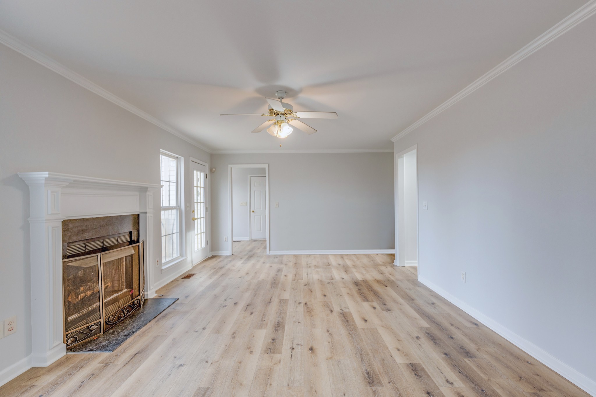 2829 Rader Ridge Court Antioch, TN 37013 - Photo 13 of 35 an empty room with wooden floor fireplace and windows